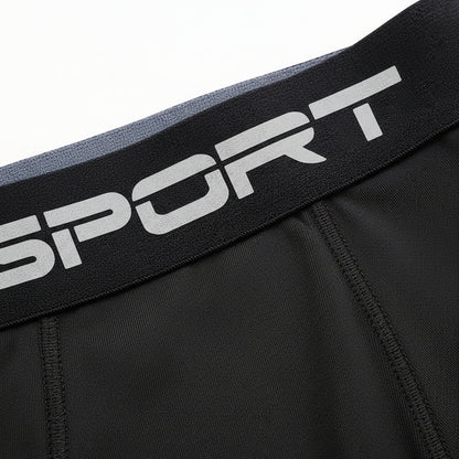 Black athletic shorts with a visible brand logo on the waistband against a white background saying sport
